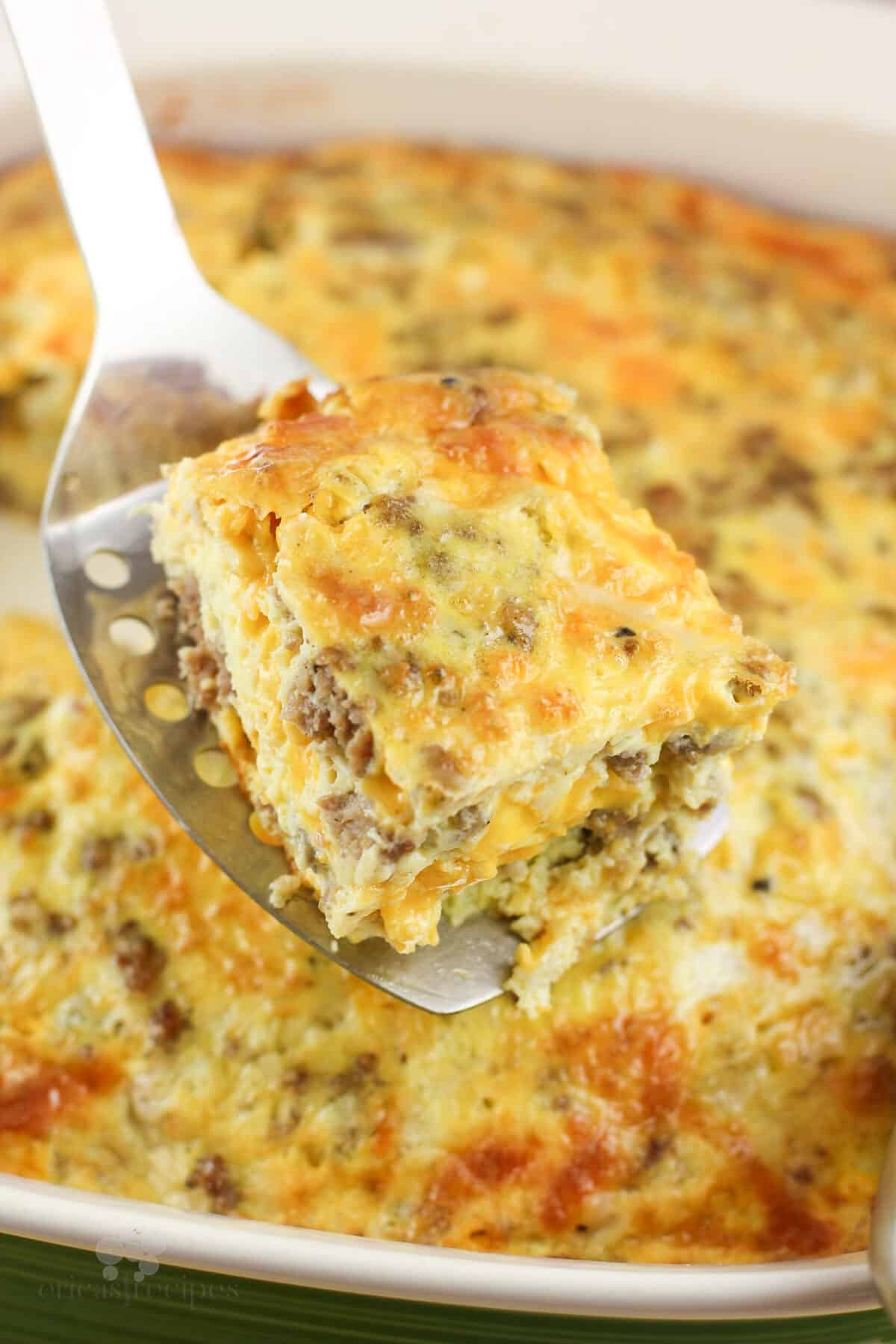 spatula holding a square portion of casserole