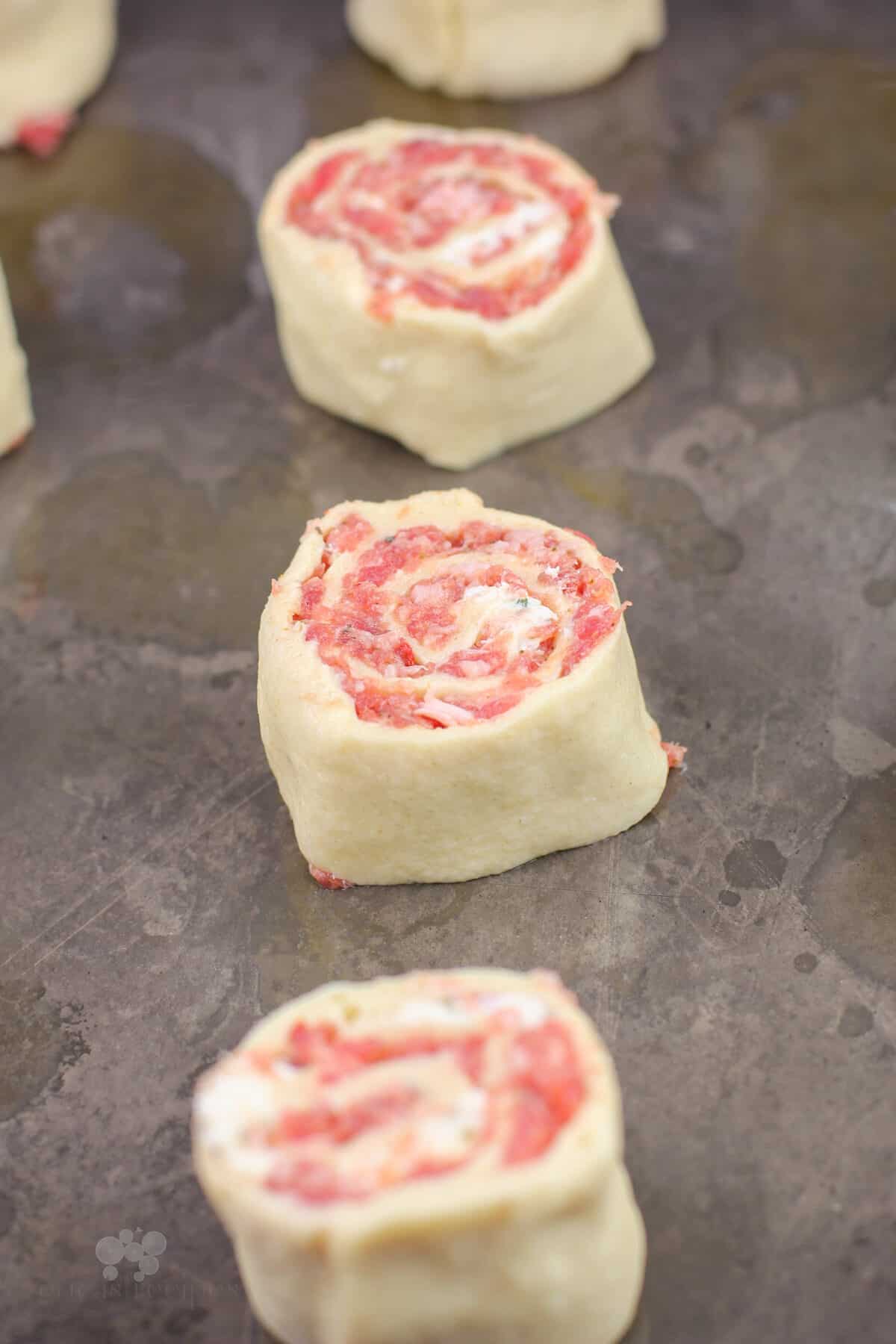 uncooked pinwheels on bake sheet