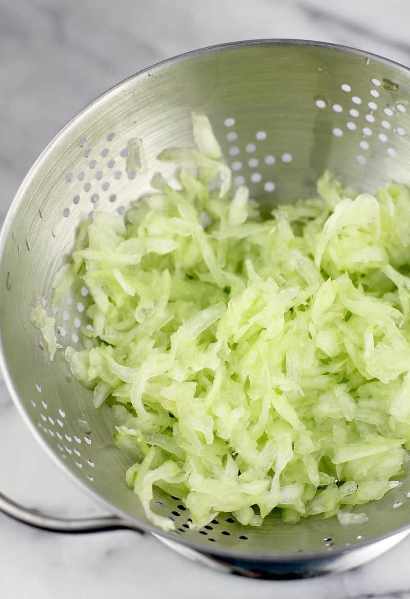 shredded cucumber for this healthy veggie dip in a strainer