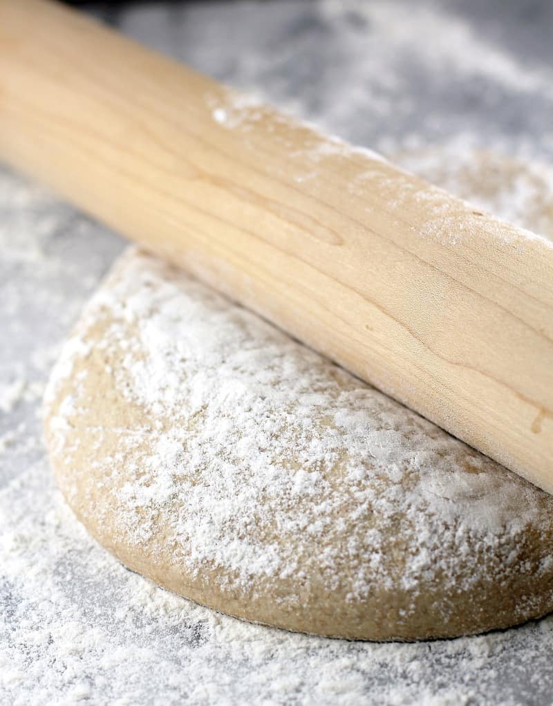 a rolling pin on a mound of whole wheat dough