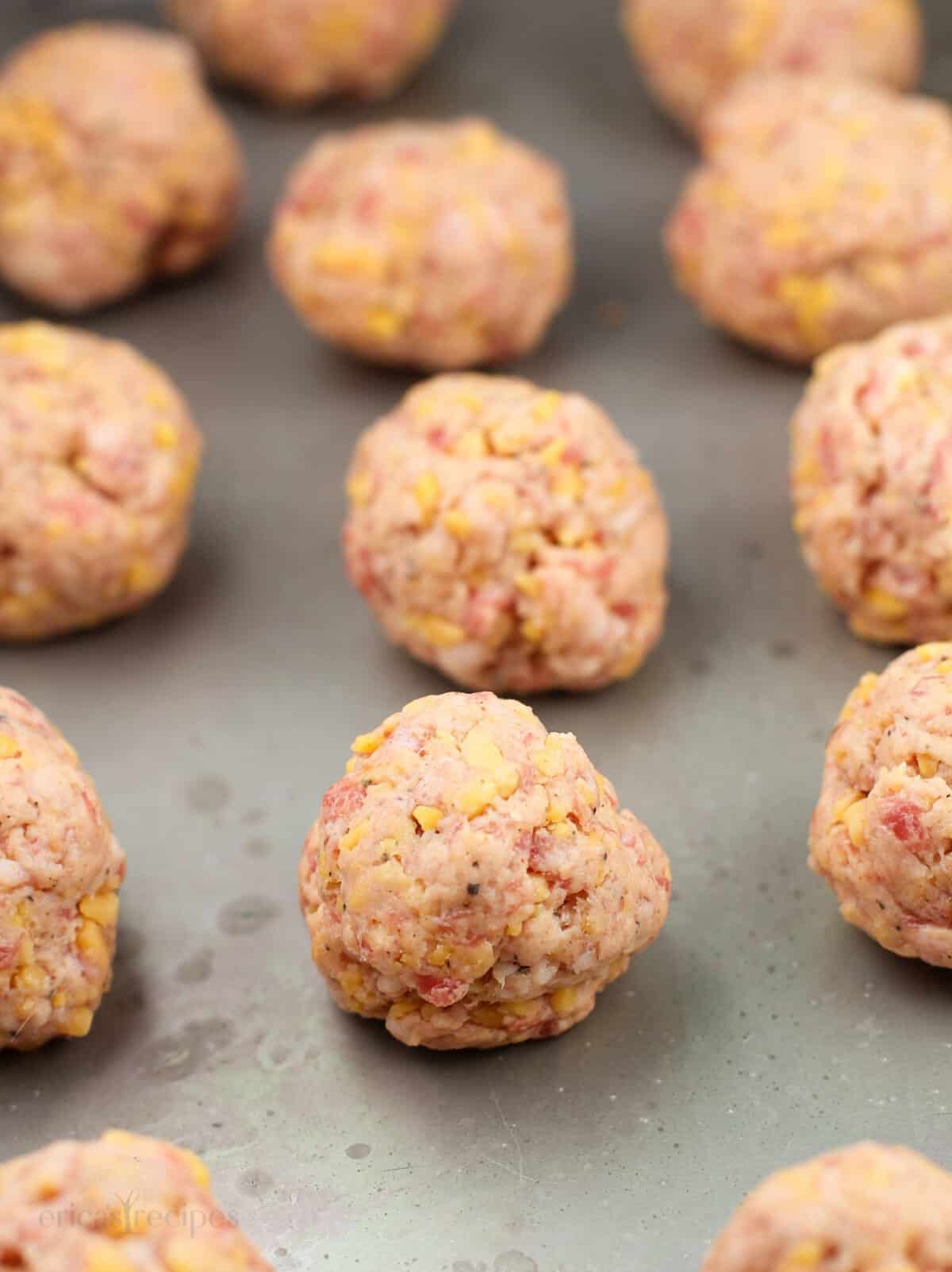 uncooked sausage balls on bake sheet
