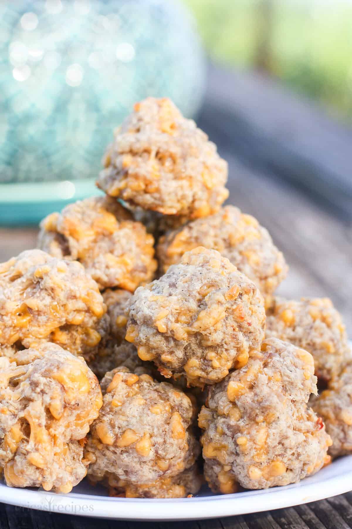 sausage balls stacked on plate outdoors