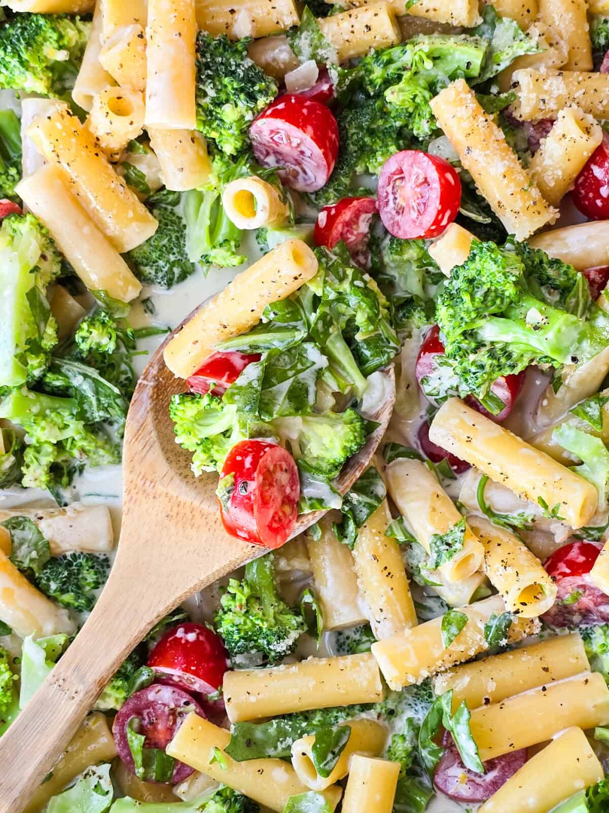 prepared lemon pasta in large skillet with wood spoon