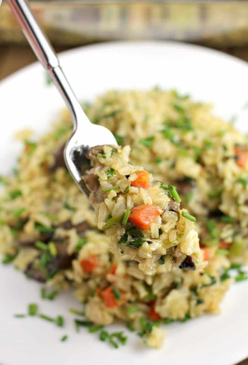 fork holding up a bite-sized amount of rice casserole