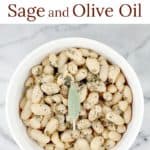 This little recipe for easy white beans is as delightful and flavorful as it is simple and inexpensive to prepare. Creamy white beans simmered in stock with sage and garlic, then tossed in smooth olive oil. Stow this recipe for a quick, vegetarian side dish and simple accompaniment, or spoon over baked potato or rice as a main course. White Beans with Sage and Olive Oil is a perfect little recipe to have on hand. #food #recipe #whitebeans #tuscanbeans #vegetarianrecipe #vegetariansidedish
