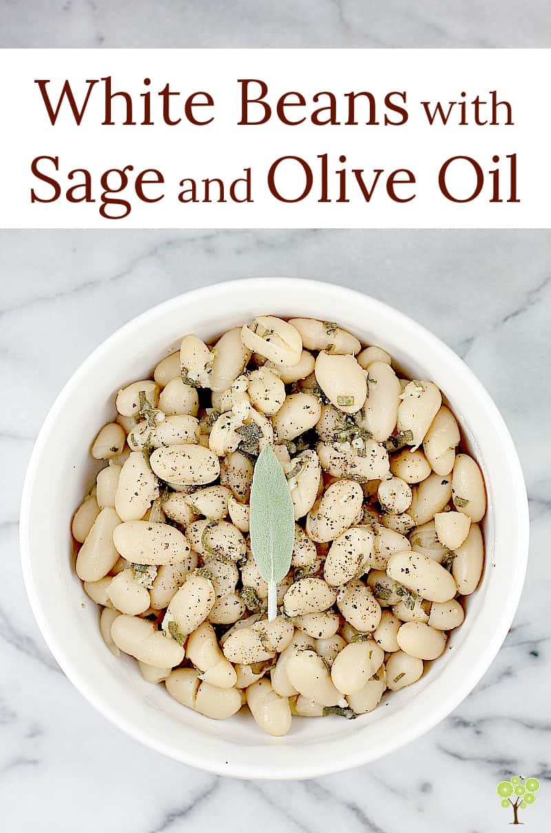 This little recipe for easy white beans is as delightful and flavorful as it is simple and inexpensive to prepare. Creamy white beans simmered in stock with sage and garlic, then tossed in smooth olive oil. Stow this recipe for a quick, vegetarian side dish and simple accompaniment, or spoon over baked potato or rice as a main course. White Beans with Sage and Olive Oil is a perfect little recipe to have on hand. #food #recipe #whitebeans #tuscanbeans #vegetarianrecipe #vegetariansidedish
