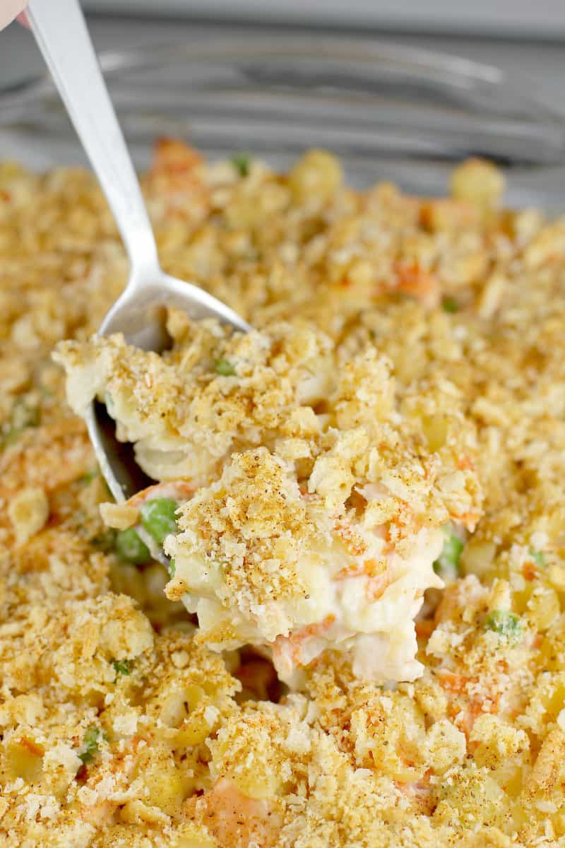 cooked fresh salmon casserole with a large spoon scooping up some in the center