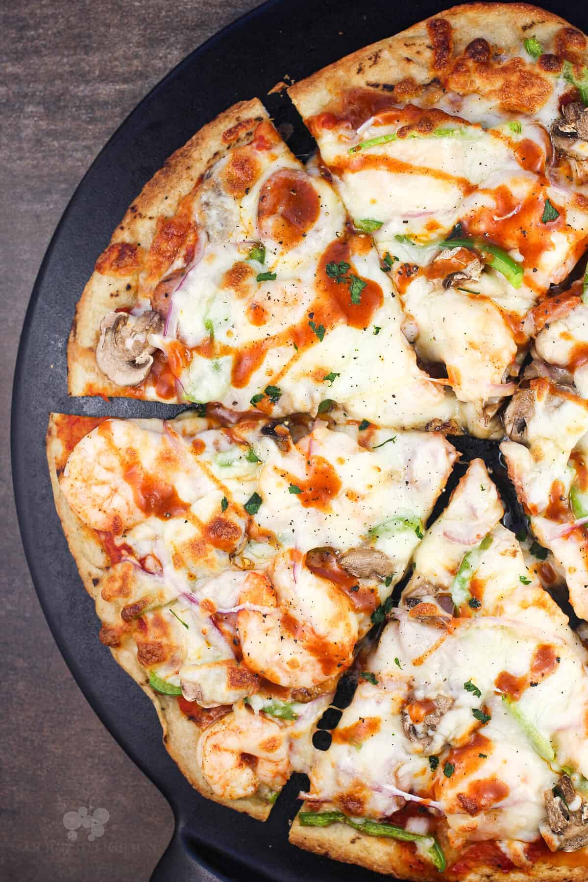 sliced pizza on black pizza stone