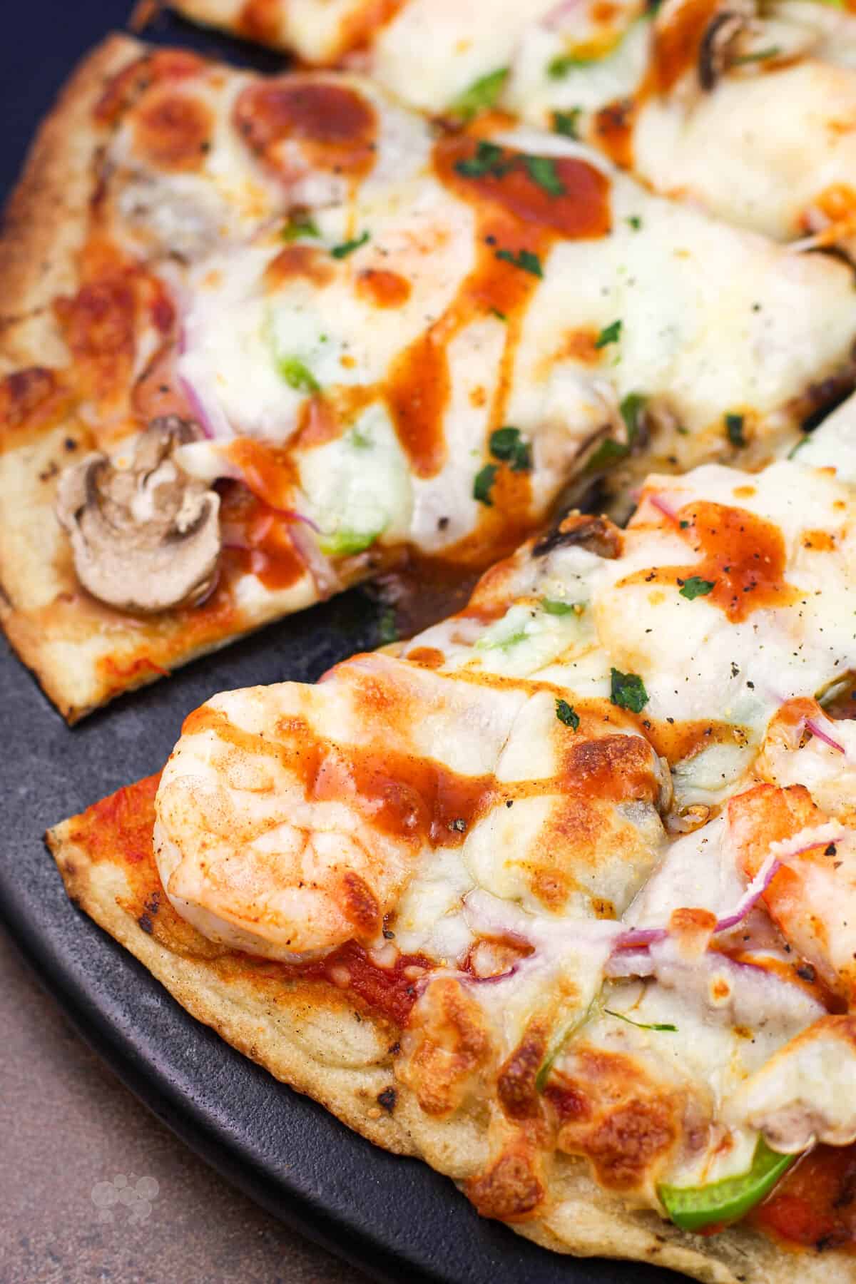 sliced pizza on black surface