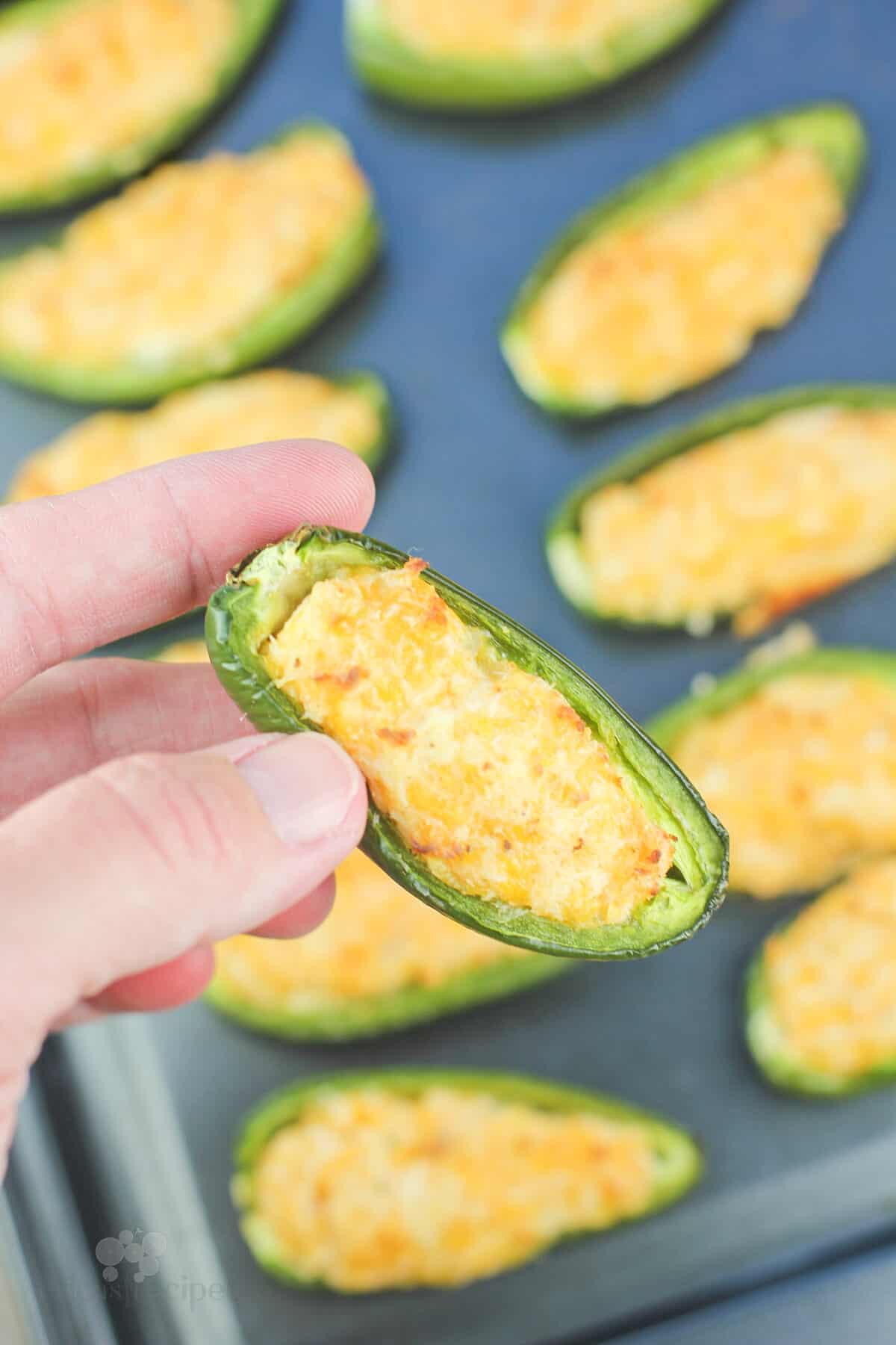 hand holding a cooked jalapeno popper