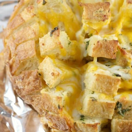 top down, zoomed view of the finished garlic cheese bread on foil