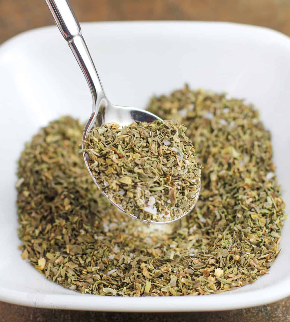 spoon mixing ingredients in white bowl