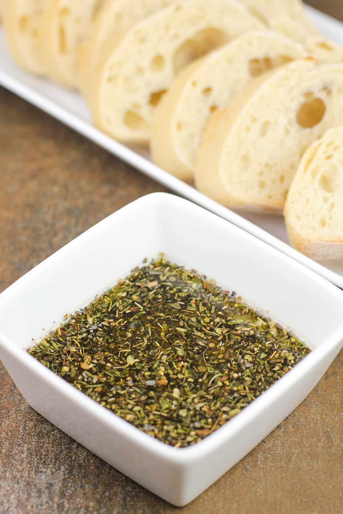 prepared recipe in small white bowl; sliced bread in background
