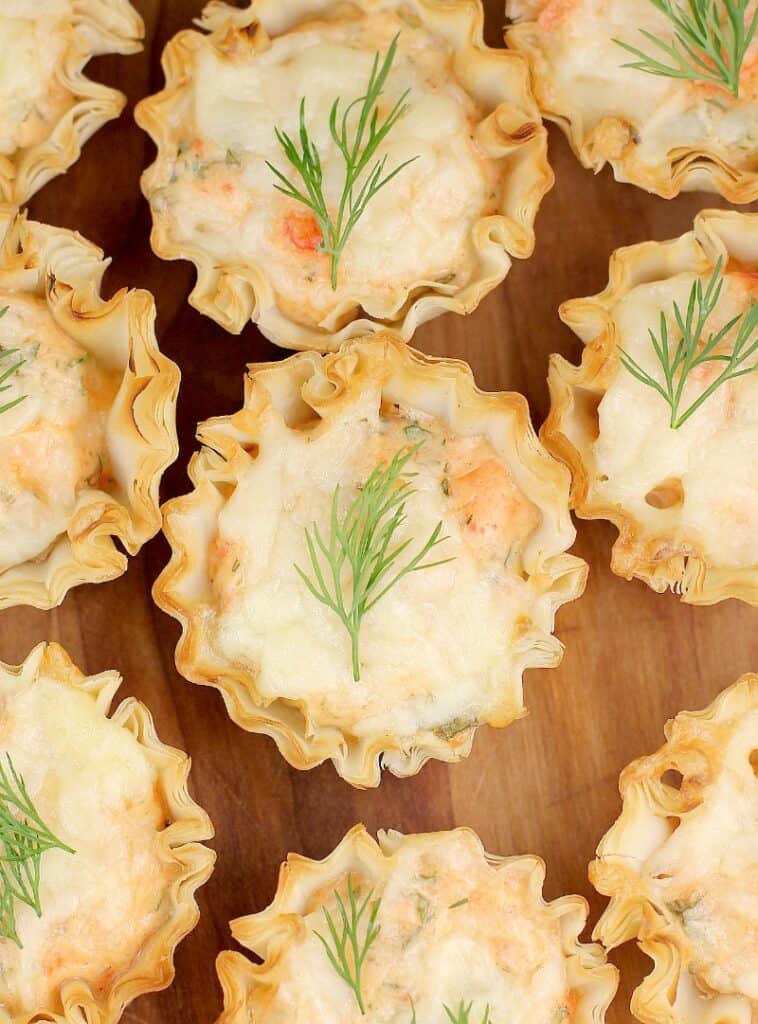 top down view of a mini smoked salmon tart with dill garnish