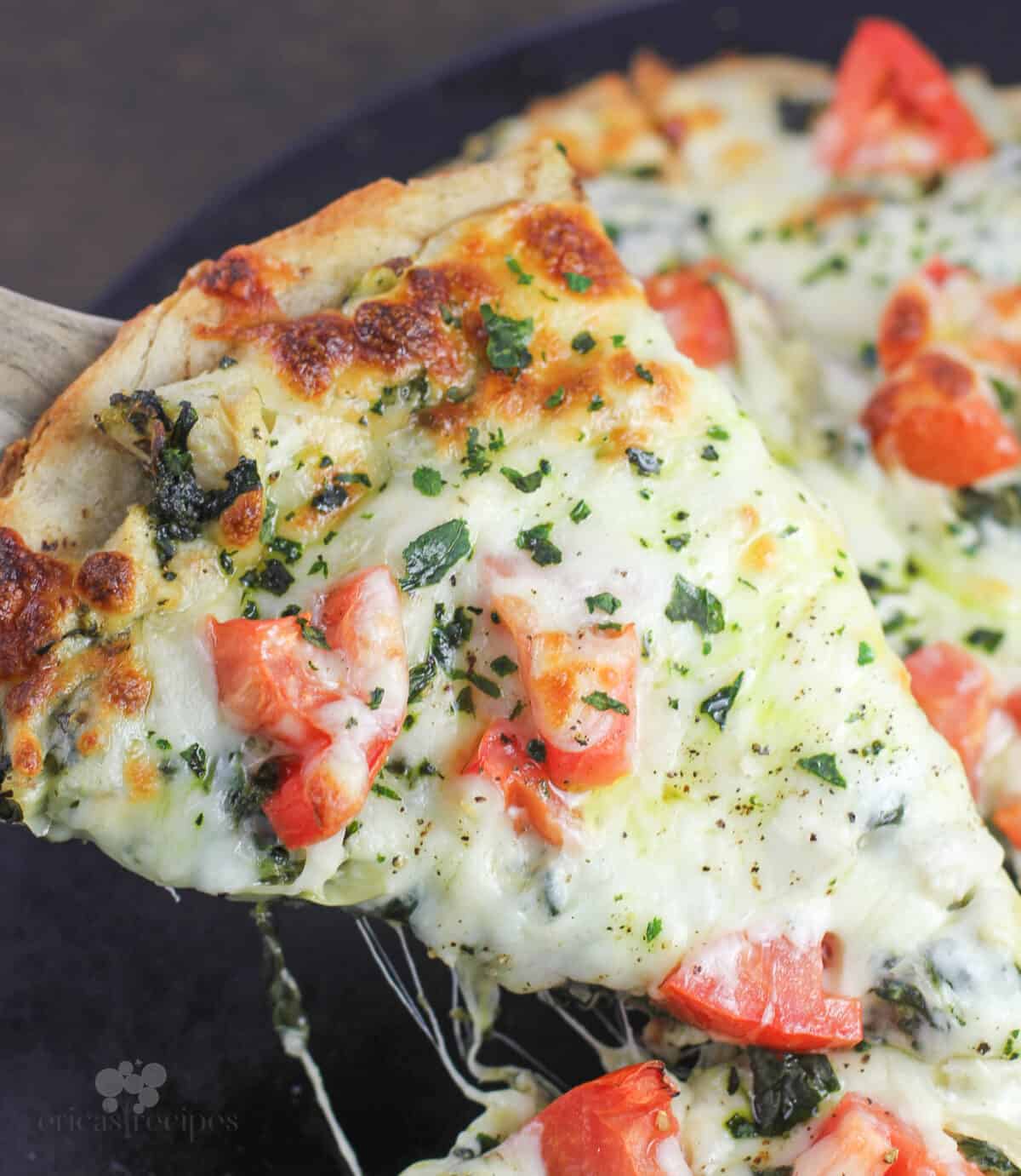 wood spatula lifting slice of pizza