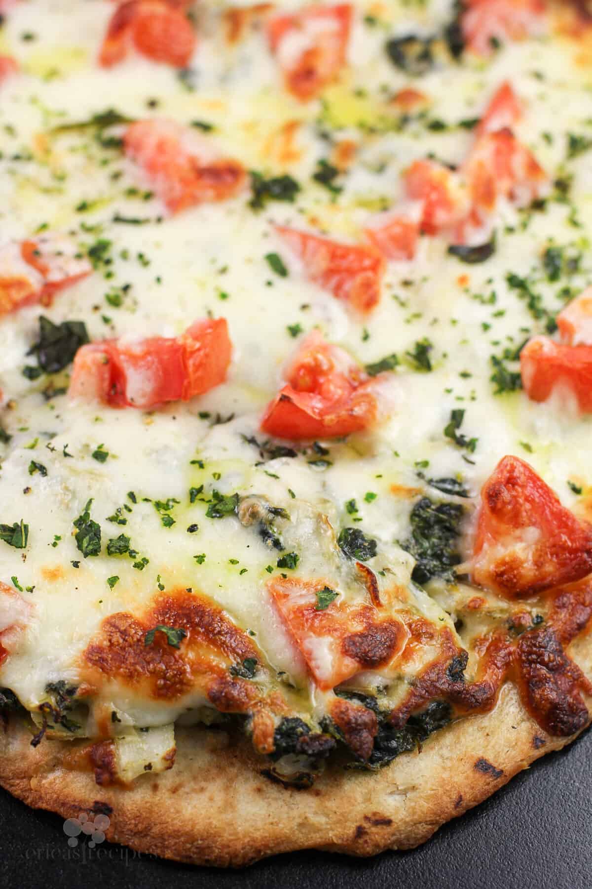 prepared pizza on pizza stone