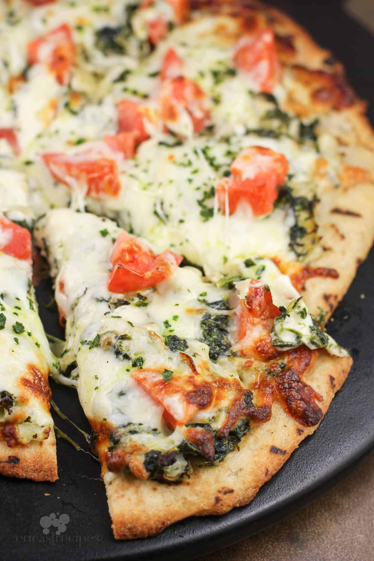 sliced pizza on pizza stone