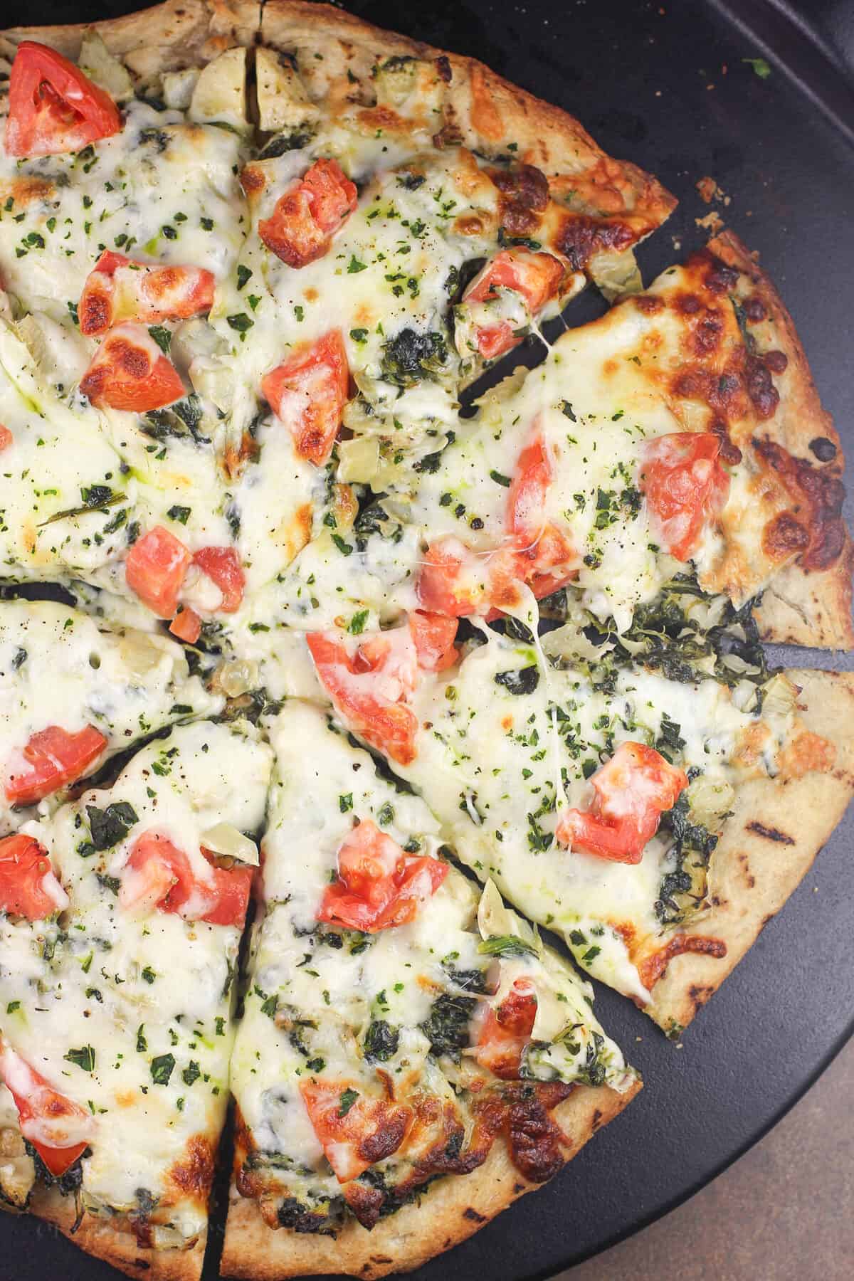 sliced pizza on pizza stone