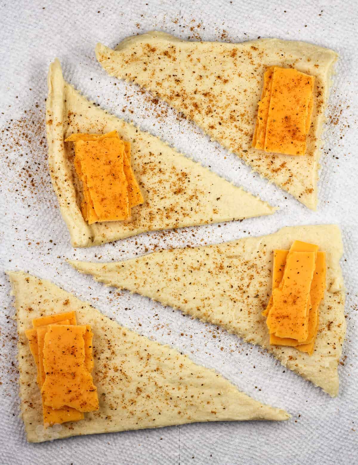 crescent dough triangles with cheese on them