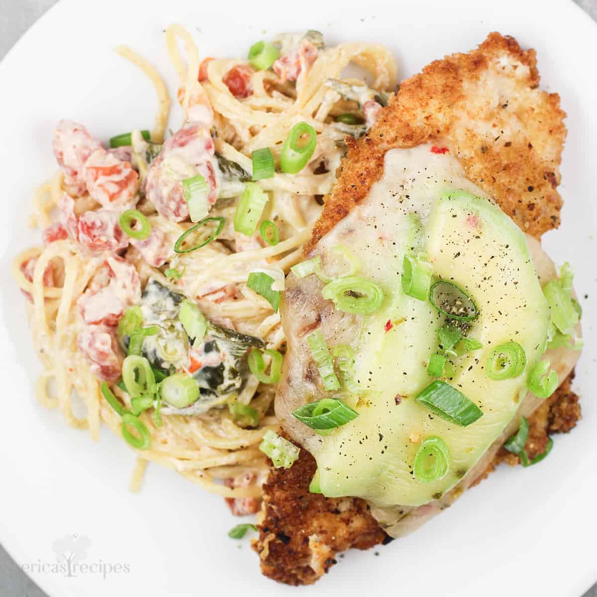 Mexicali chicken parmesan with spicy alfredo sauce pasta on white plate