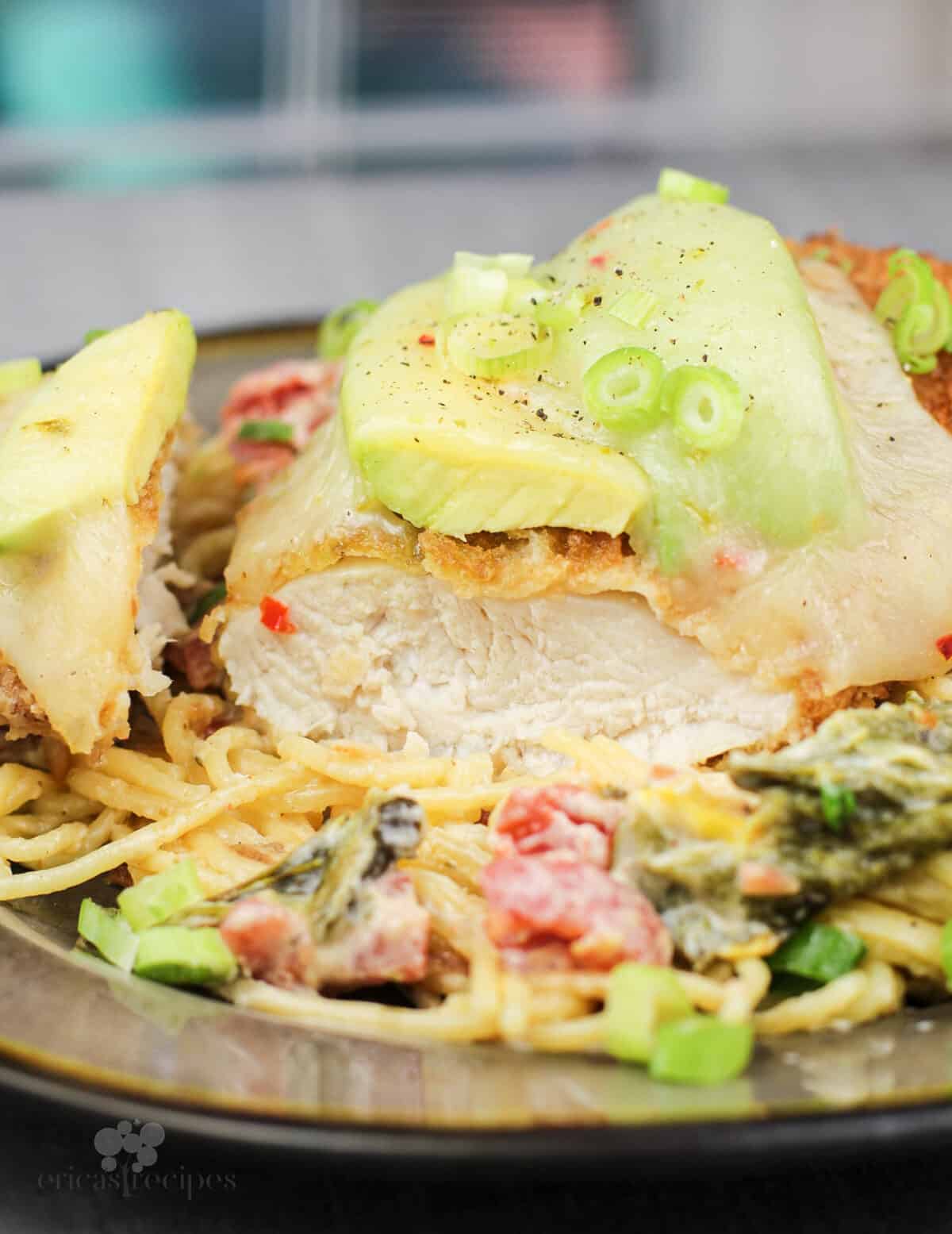 prepared recipe on plate, chicken cut to show doneness