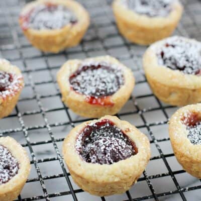 finished cherry cup cookies on a cooling rack over a marble board