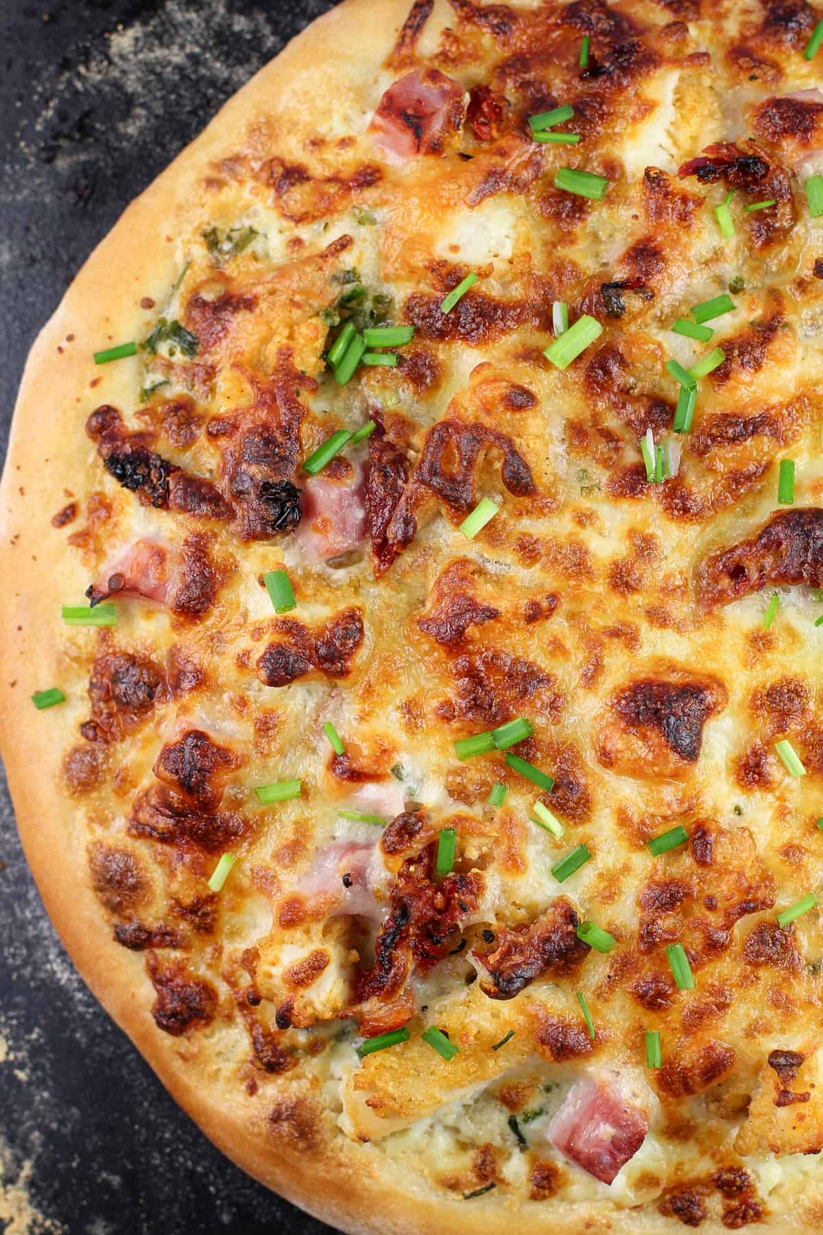 cooked pizza on black pizza stone