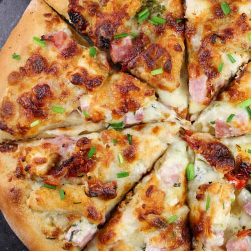 sliced pizza on black pizza stone