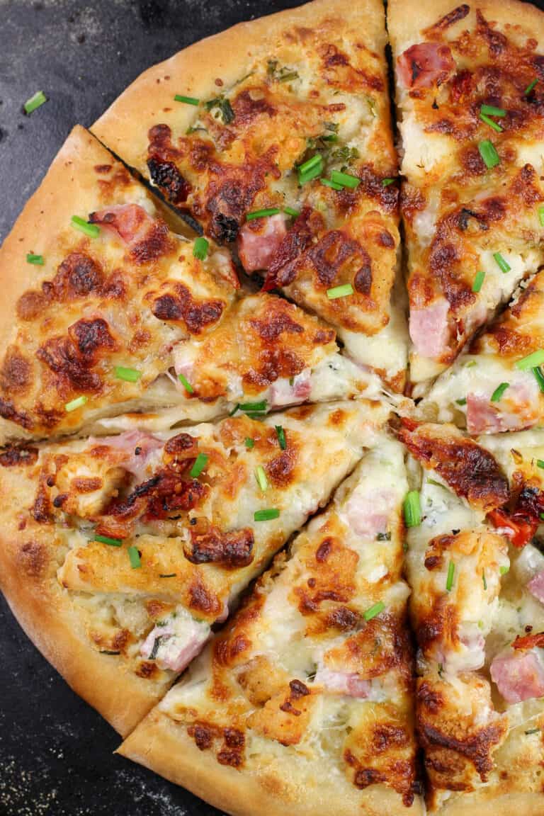 sliced pizza on black pizza stone