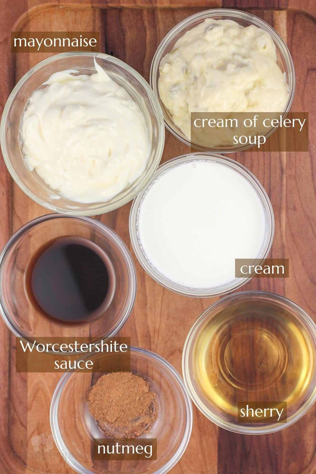 6 small glass bowls, each with an ingredient for Divan sauce