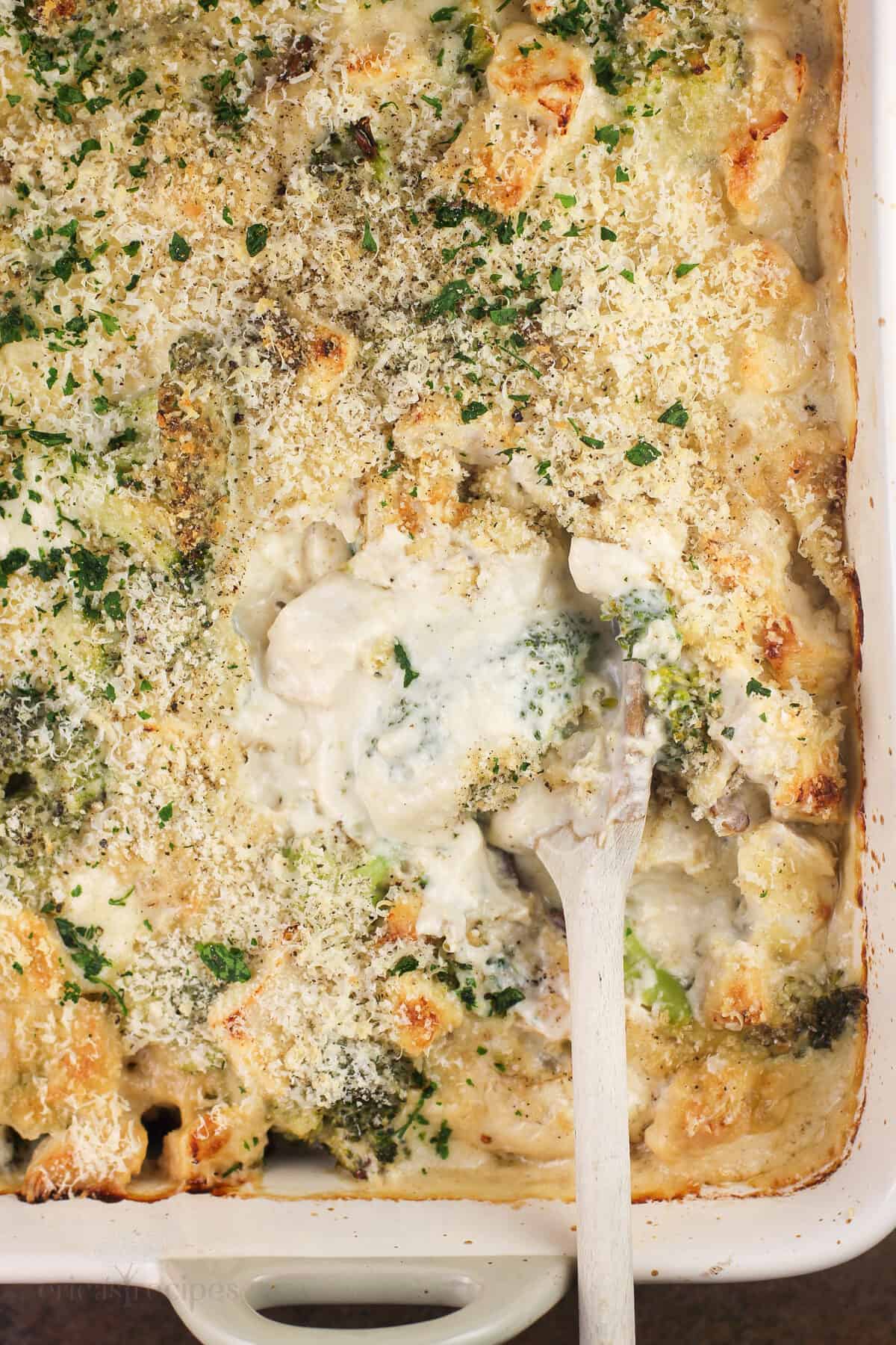top down view of prepared recipe in casserole dish with wood spoon