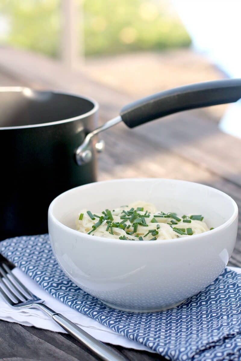 white bowl and black saucepan on picnic table