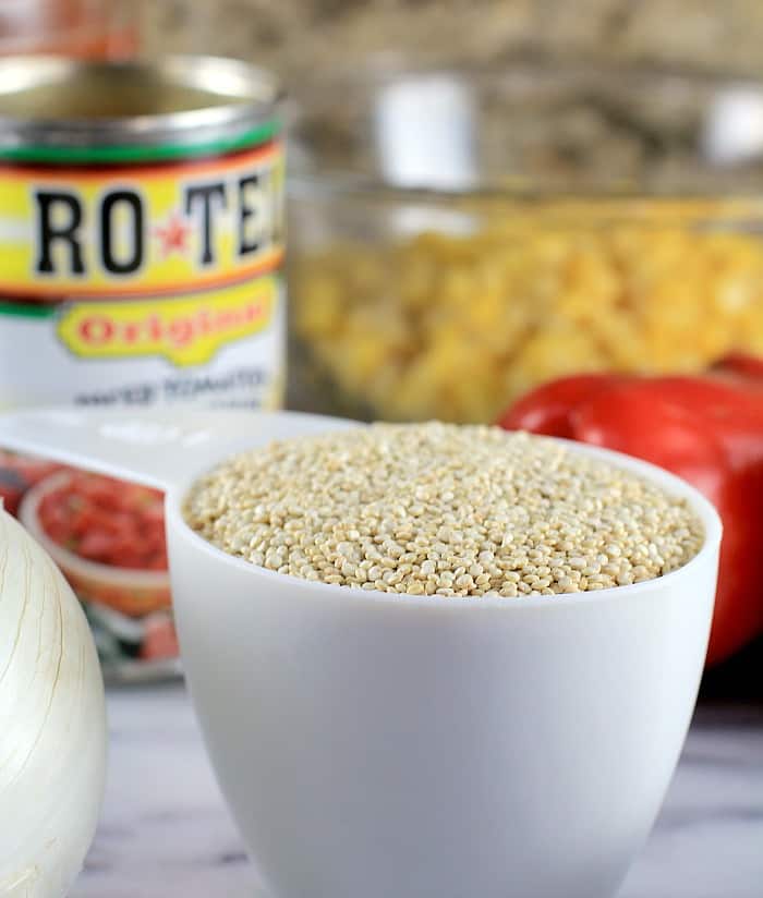 white measure cup with quinoa