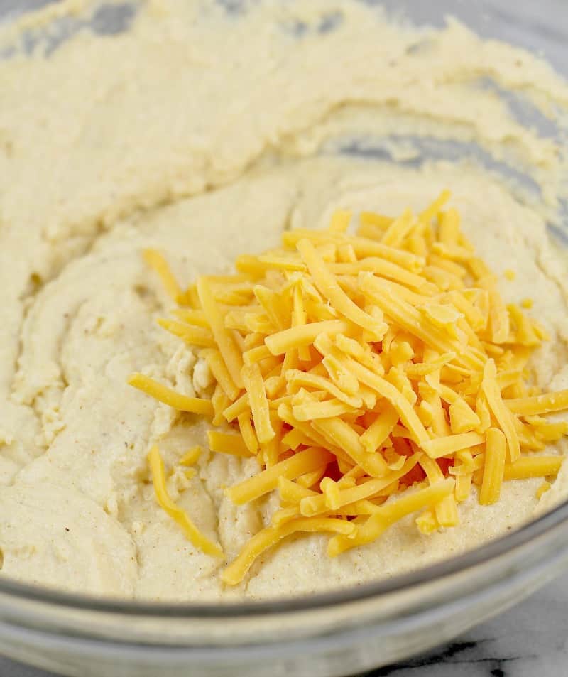 shredded cheddar cheese on batter prior to mixing