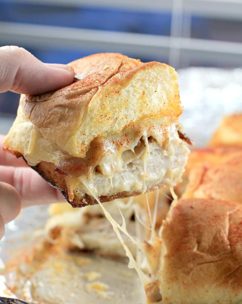 side view showing the slider being lifed up to show melty cheese