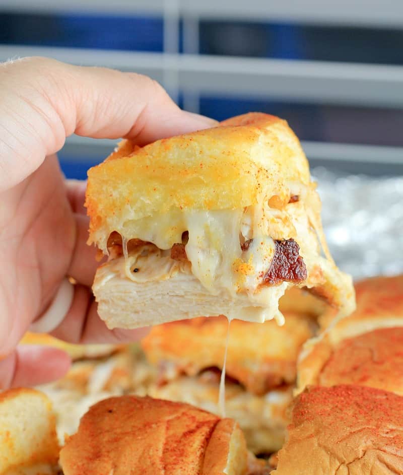 side view showing the slider being lifed up to show melty cheese