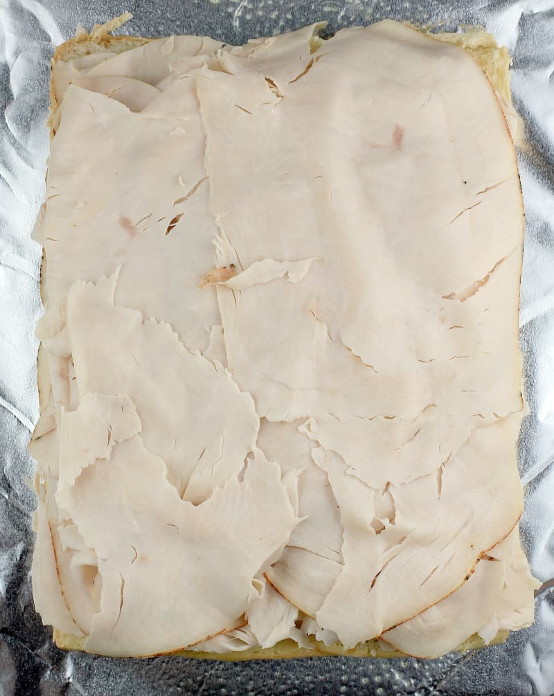 top view of the turkey layered on the bread