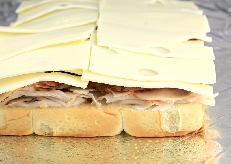 side view showing the turkey, bacon, and cheese stacked