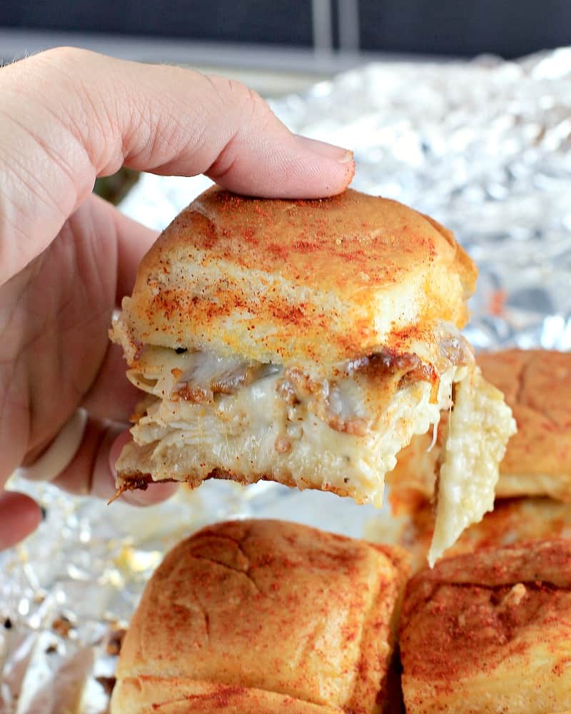 side view showing the slider being lifed up to show melty cheese
