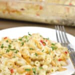image for pinterest of plated crab mac and cheese with text overlay of recipe title