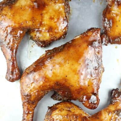 smoked chicken quarters on a bake sheet