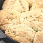 image for Pinterest with a pan of honey biscuits and text overlay Grilled Honey Biscuits with Thyme