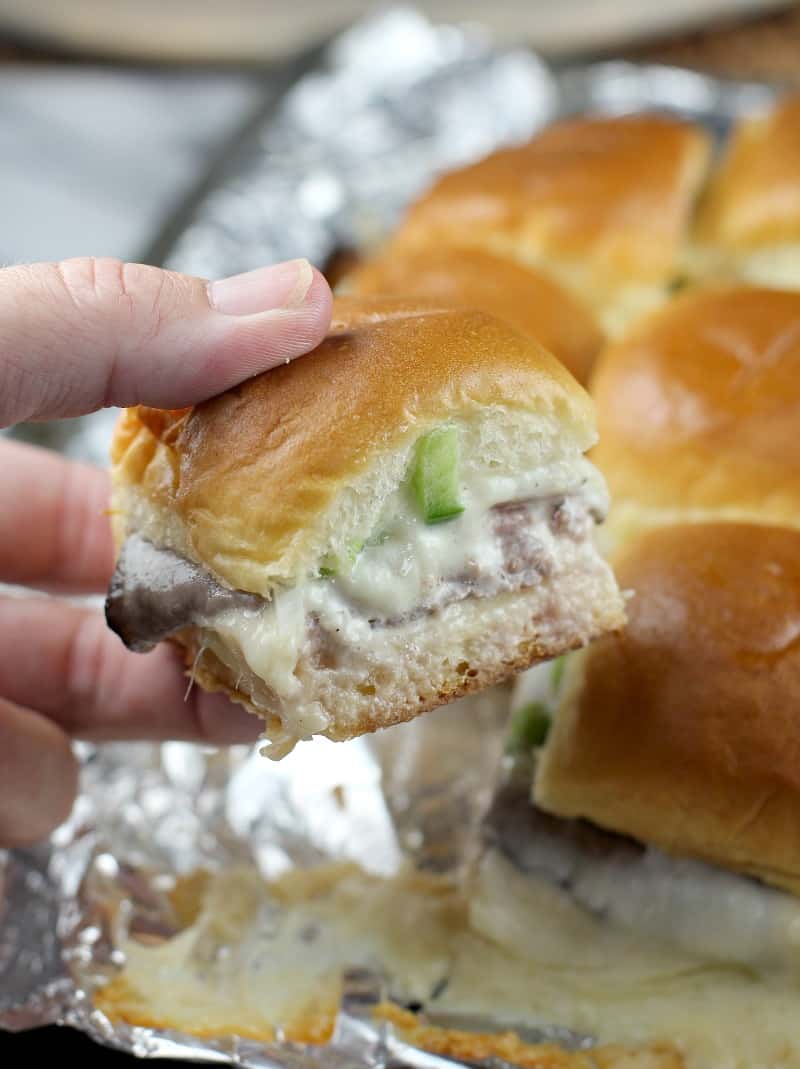 hand holding a slider; remaining sliders in the background
