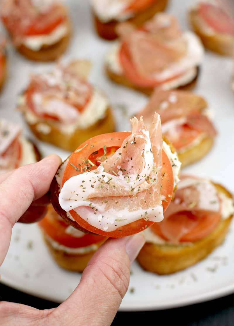 hand holding a crostini
