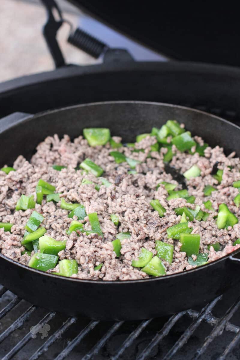cooked ground beef with green bell pepper in pan on grill