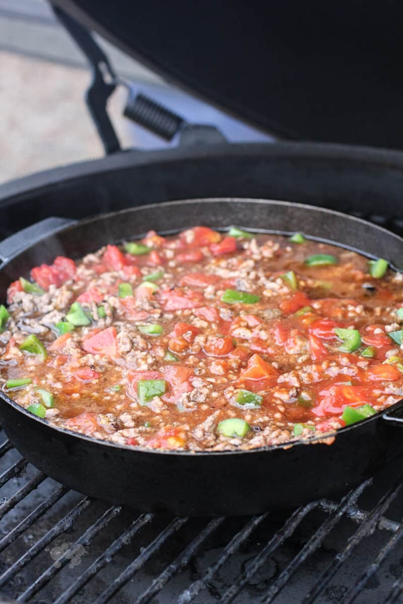 assembled sloppy joe ingredients in pan on Big Green Egg grill grate