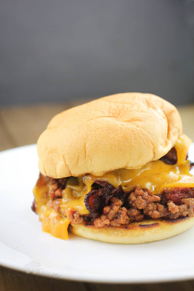 side view of finished sloppy joe sandwich on white plave