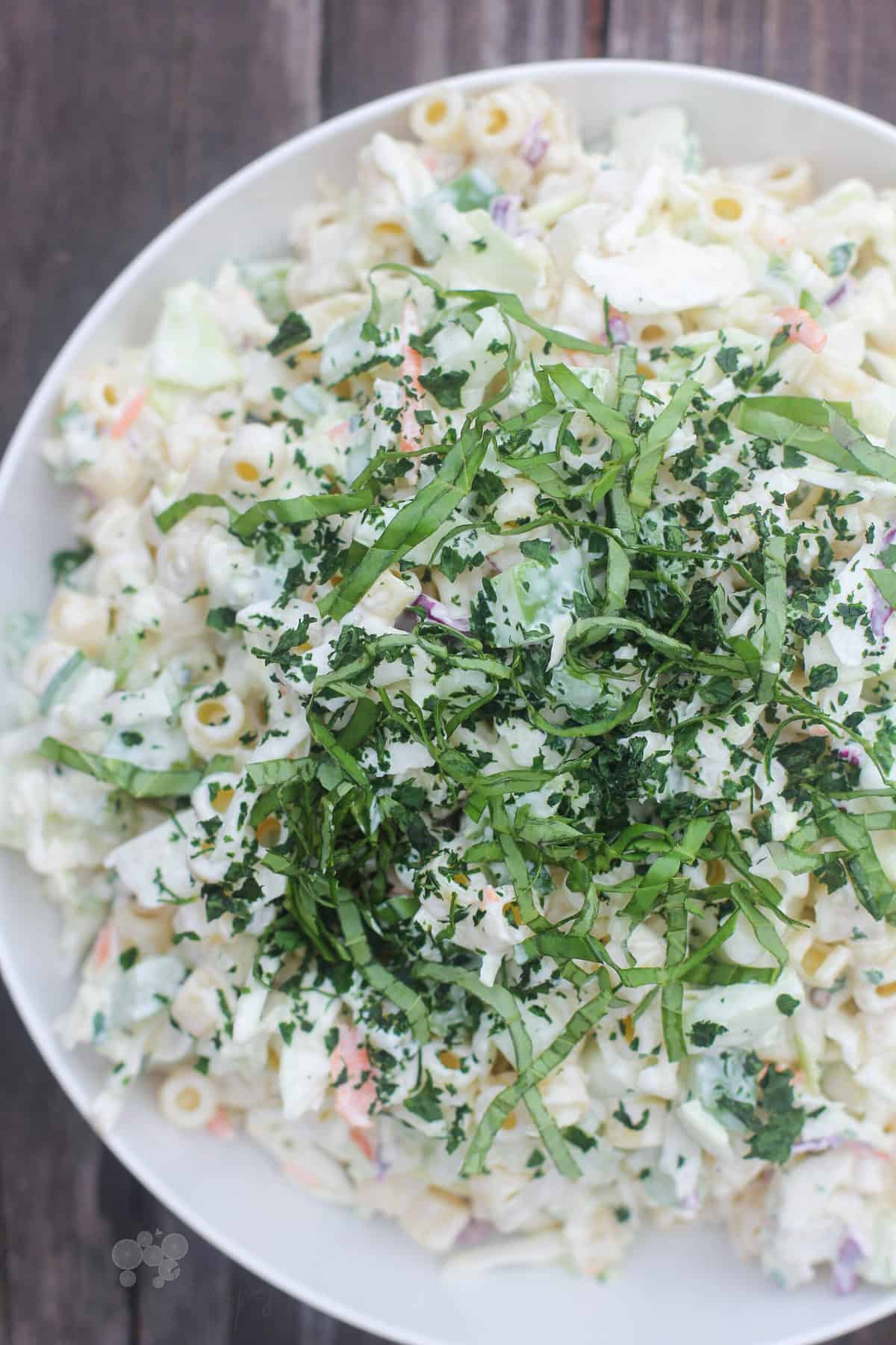 prepared salad in white bowl on weathered wood background