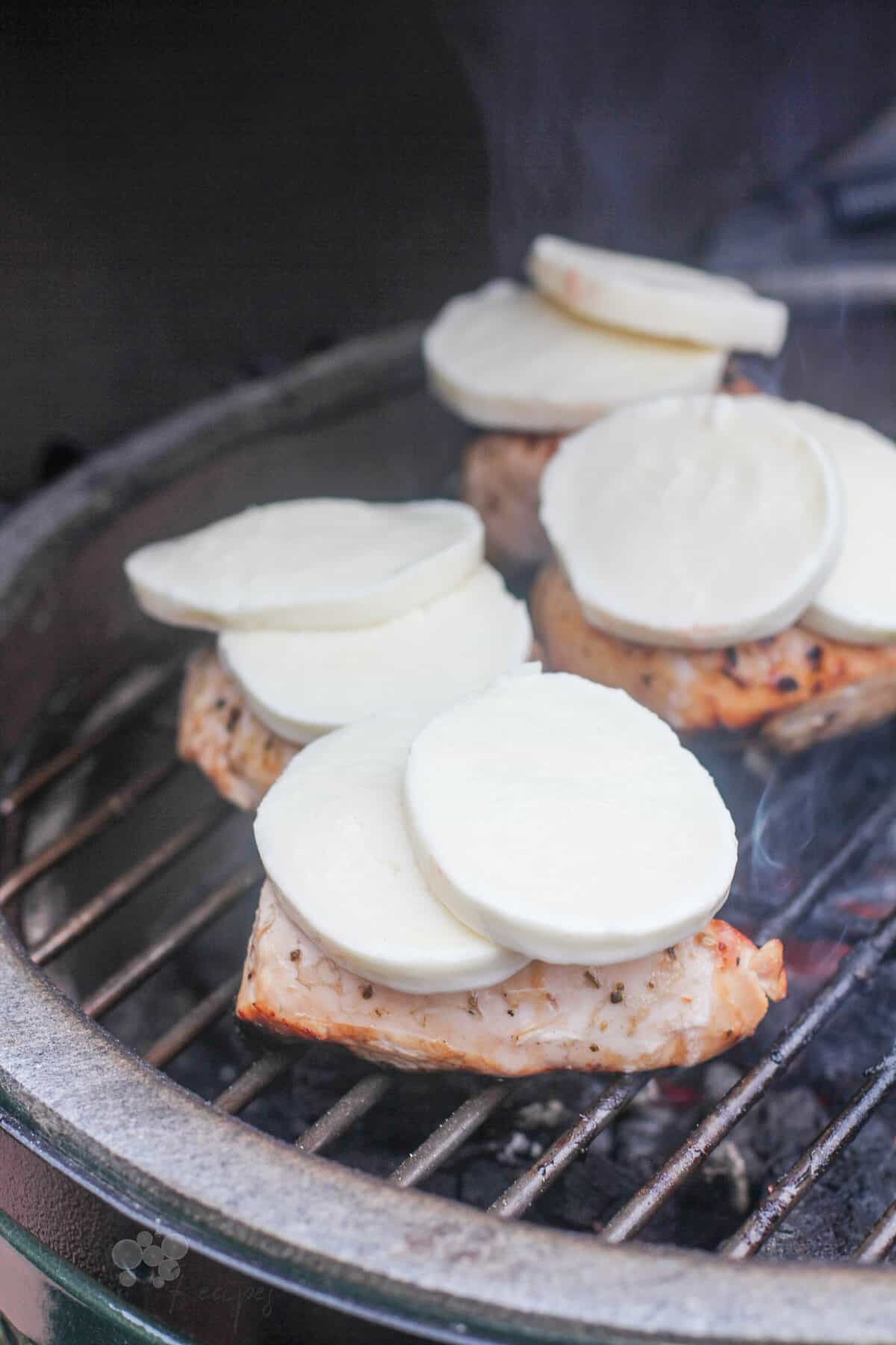 chicken on grill topped with cheese