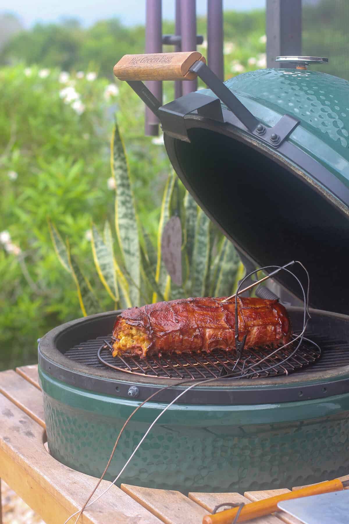 open Big Green Egg with smoked fatty; probe inserted in the meat
